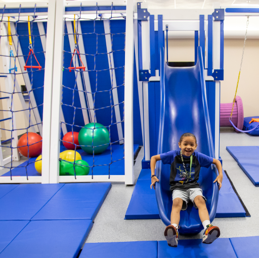 Child smiling on a slide