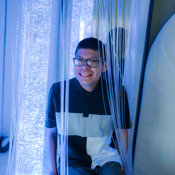 Boy smiling in a sensory room