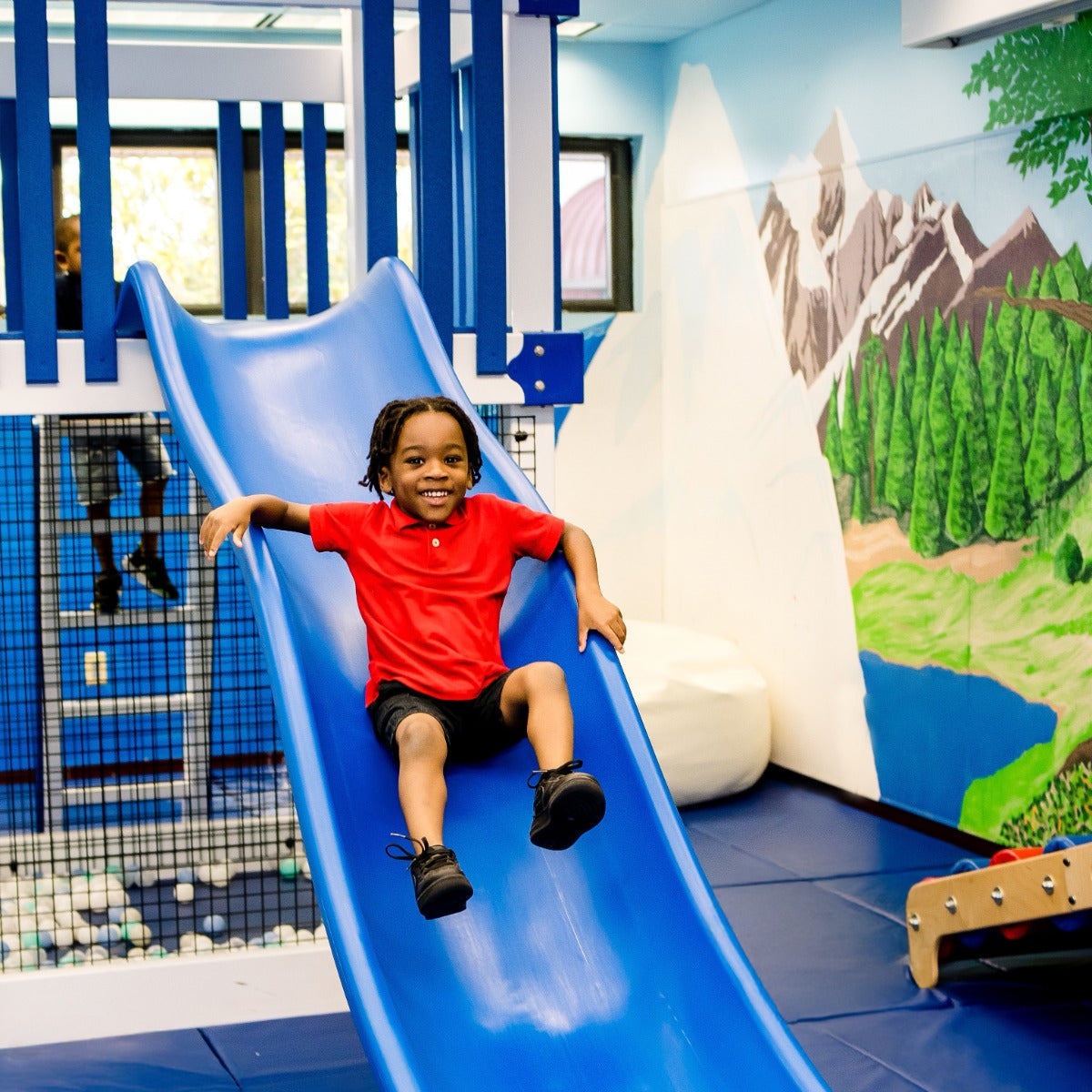 Child smiling on a slide