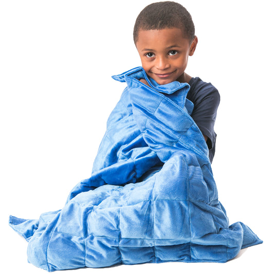 Boy smiling while using the blue Soft Plush Weighted Blanket