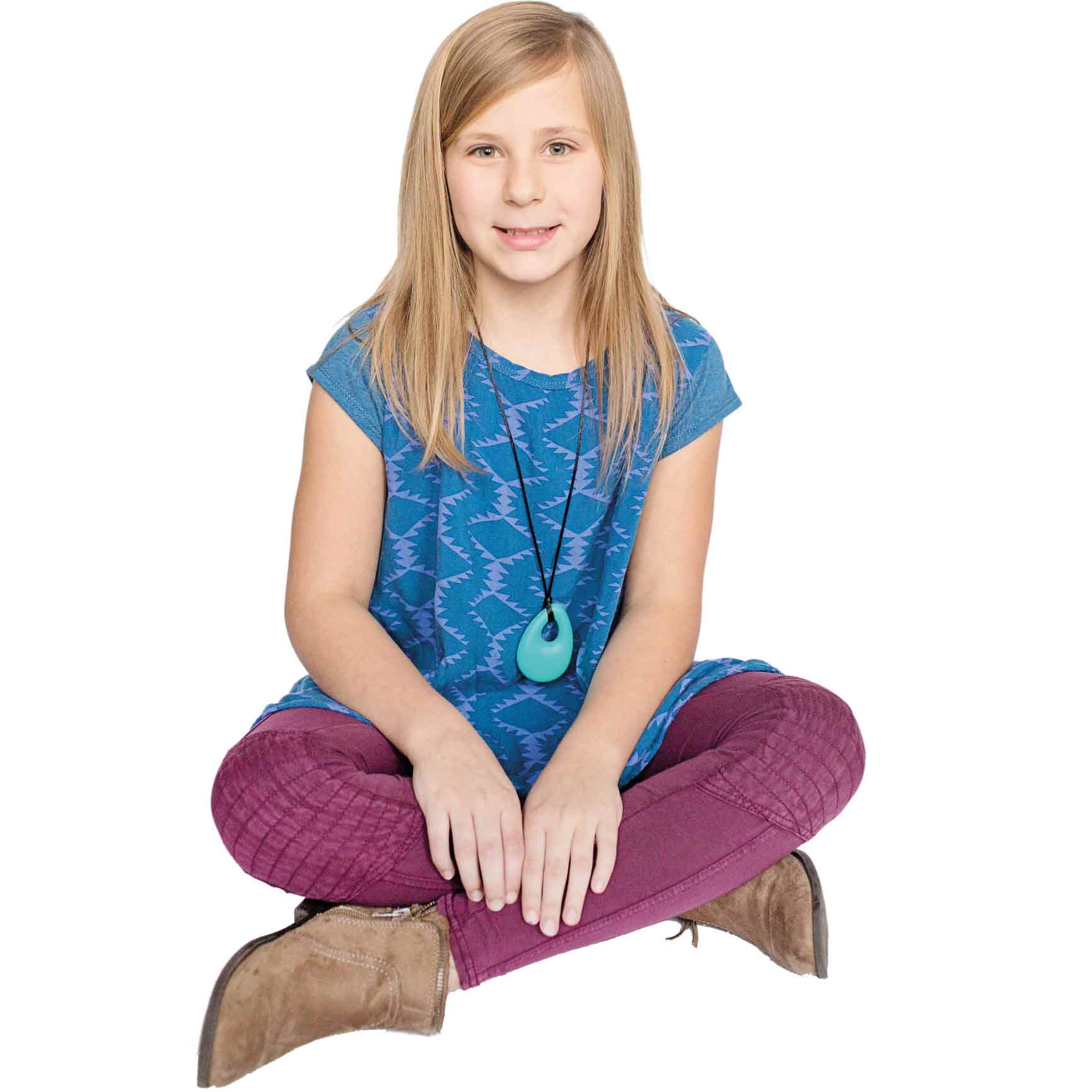 Girl sitting down and smiling while wearing the Turquoise Egg Pendant