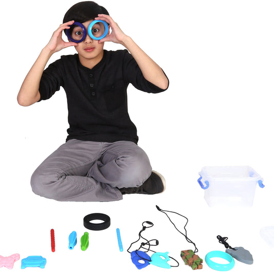 Boy playing with the Bucket of 15 silicone chewies including necklaces, bangles and pencil toppers
