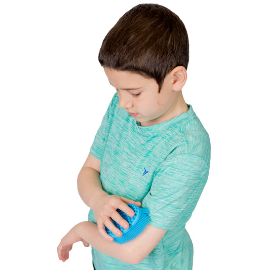 Boy using the blue Large Silicone Sensory Brush