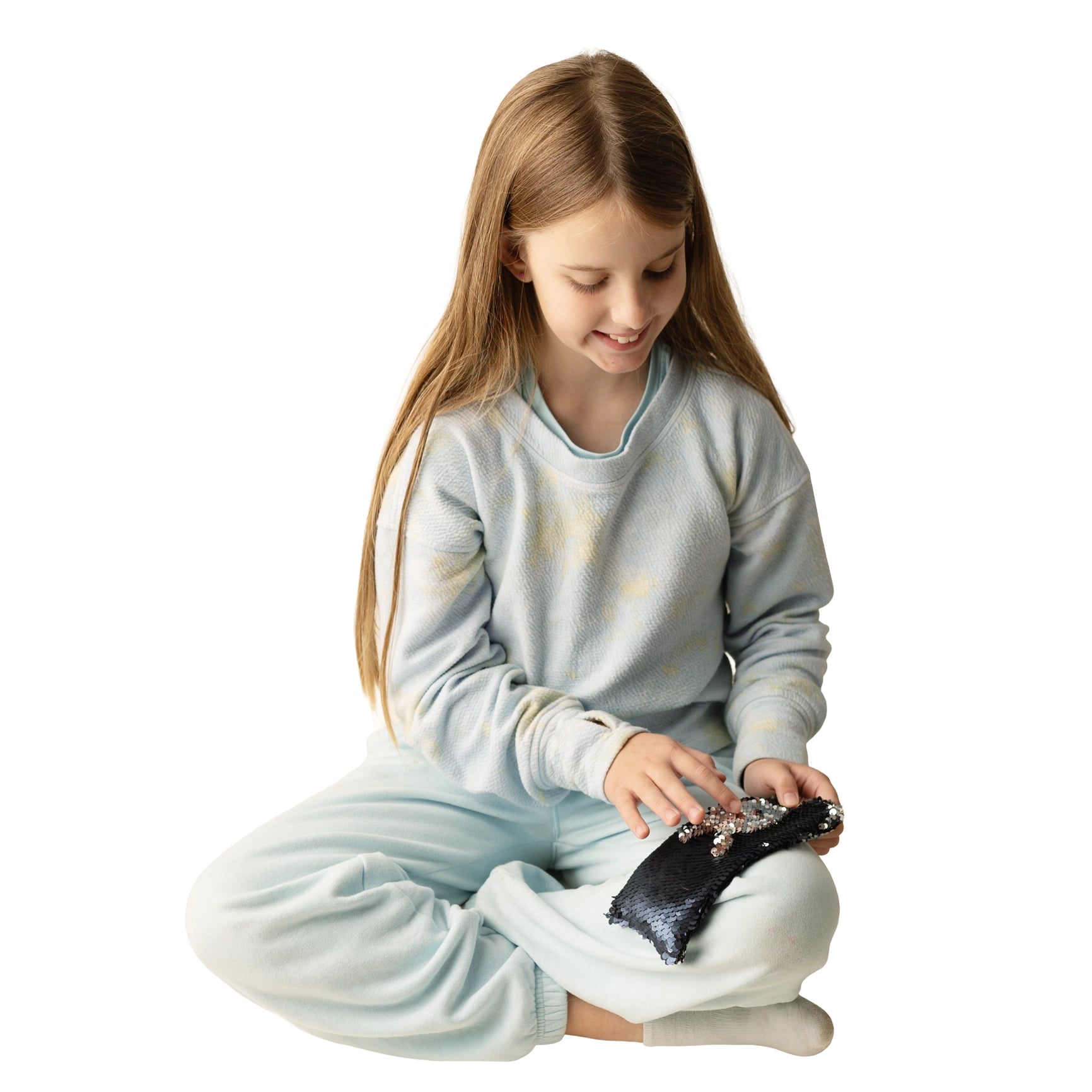 Girl sitting and using the Weighted Sequin Fidget