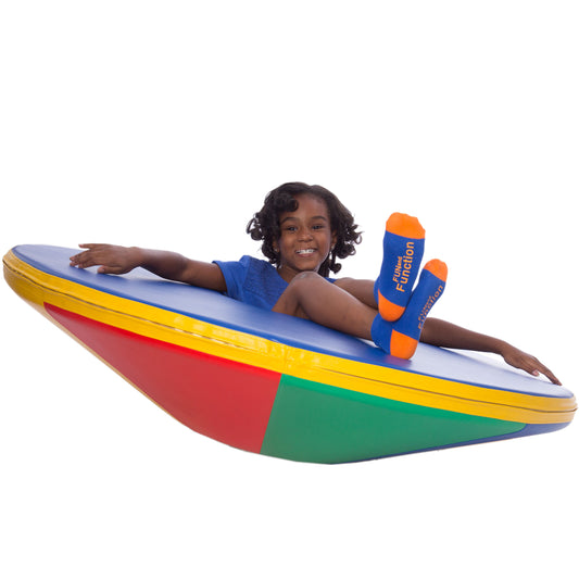 Girl smiling while playing on the SensaSoft™ Rockin Roll Top