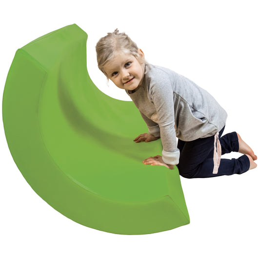 Child smiling while using the green SensaSoft™ Rocking Half Barrel