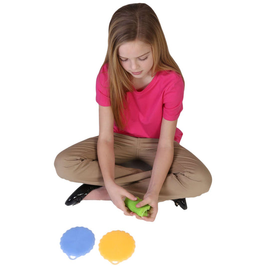 Girl playing with the blue, green and yellow Sensational Textured Circle Fidgets