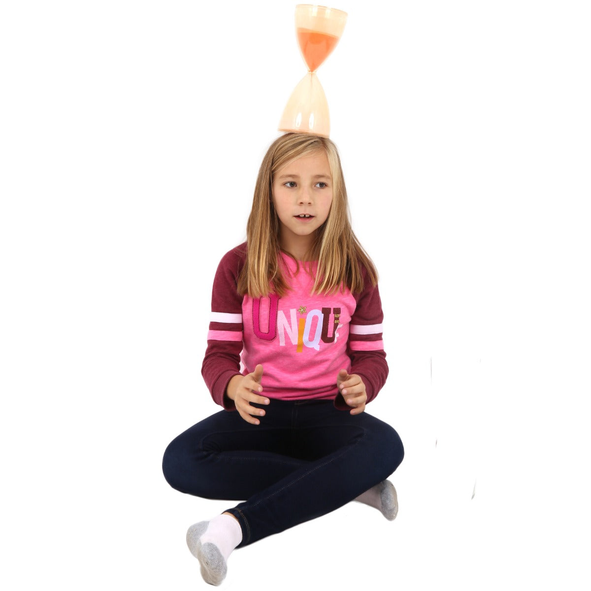 Girl balancing the Sand Timer on her head