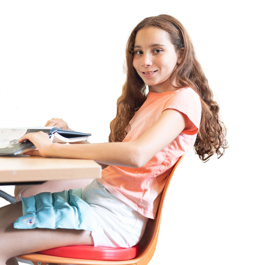 Girl reading at a desk while using the Sit-A-Round Cushion