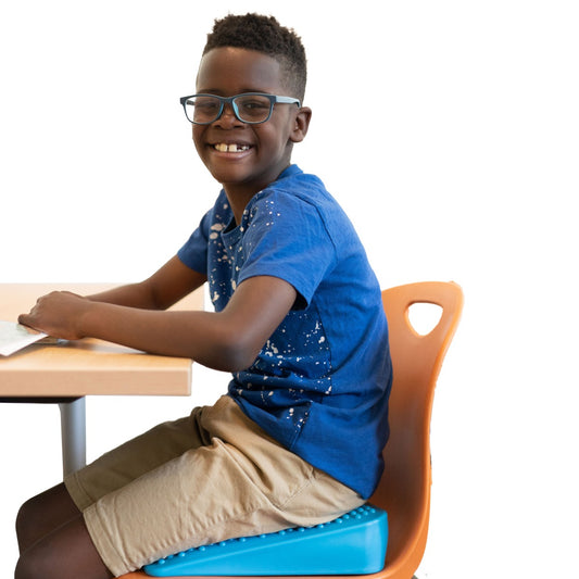 boy sitting at a desk using the Move N Rock Study Kit