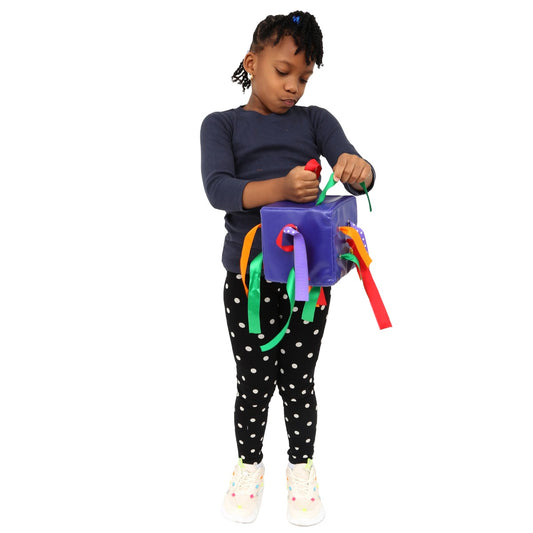Girl using the Wipe Clean Ribbon Push and Pull Cube
