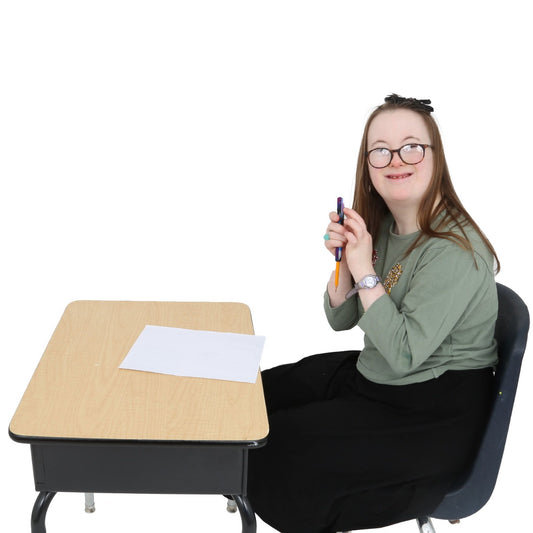 Girl sitting at a desk, using the Chewy Pencil Sleeve