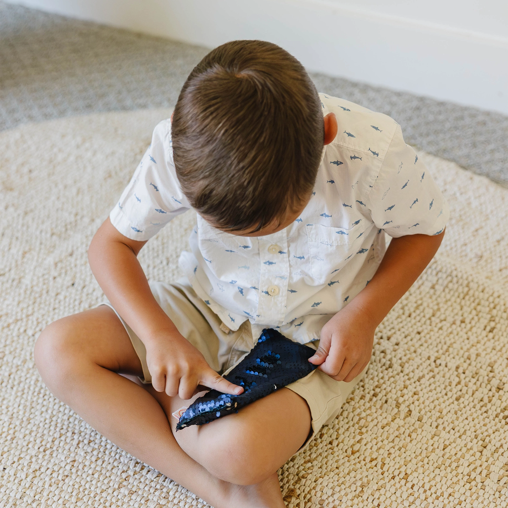 Boy using the Weighted Sequin Fidget