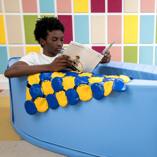 Boy reading inside the SensaSoft™ Compression Canoe
