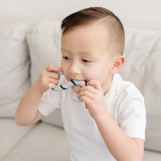 Child biting a Sensory Basics S-Chidget