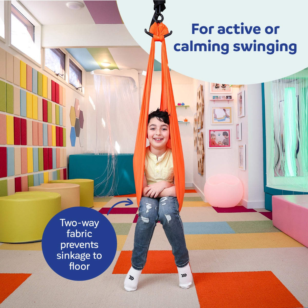 boy sitting indoors on orange Cozy Compression Swing