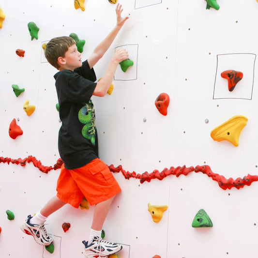 Boy using the Discovery Dry Erase Climbing Wall 8'
