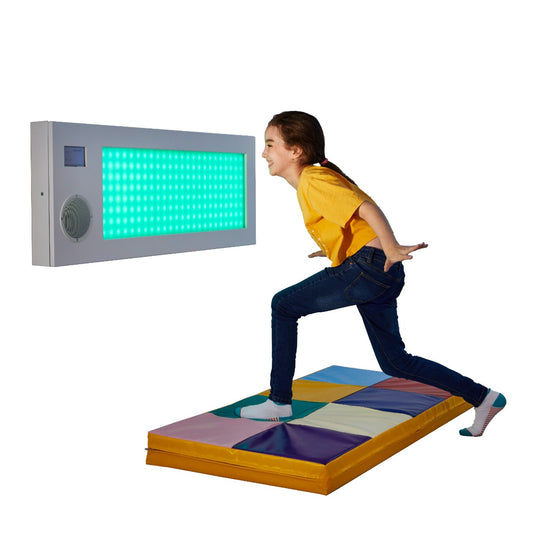 Girl smiling while using the SensaSoft™ Musical Lightup Hopscotch