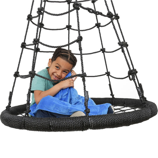 Boy smiling while sitting on the Web Tower Swing