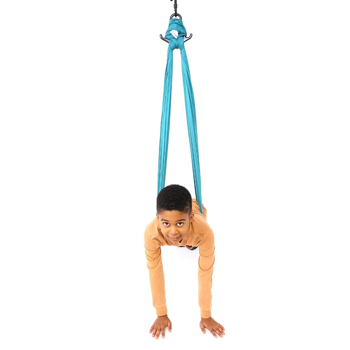 boy laying from the teal Cozy Compression Swing with hands on the floor