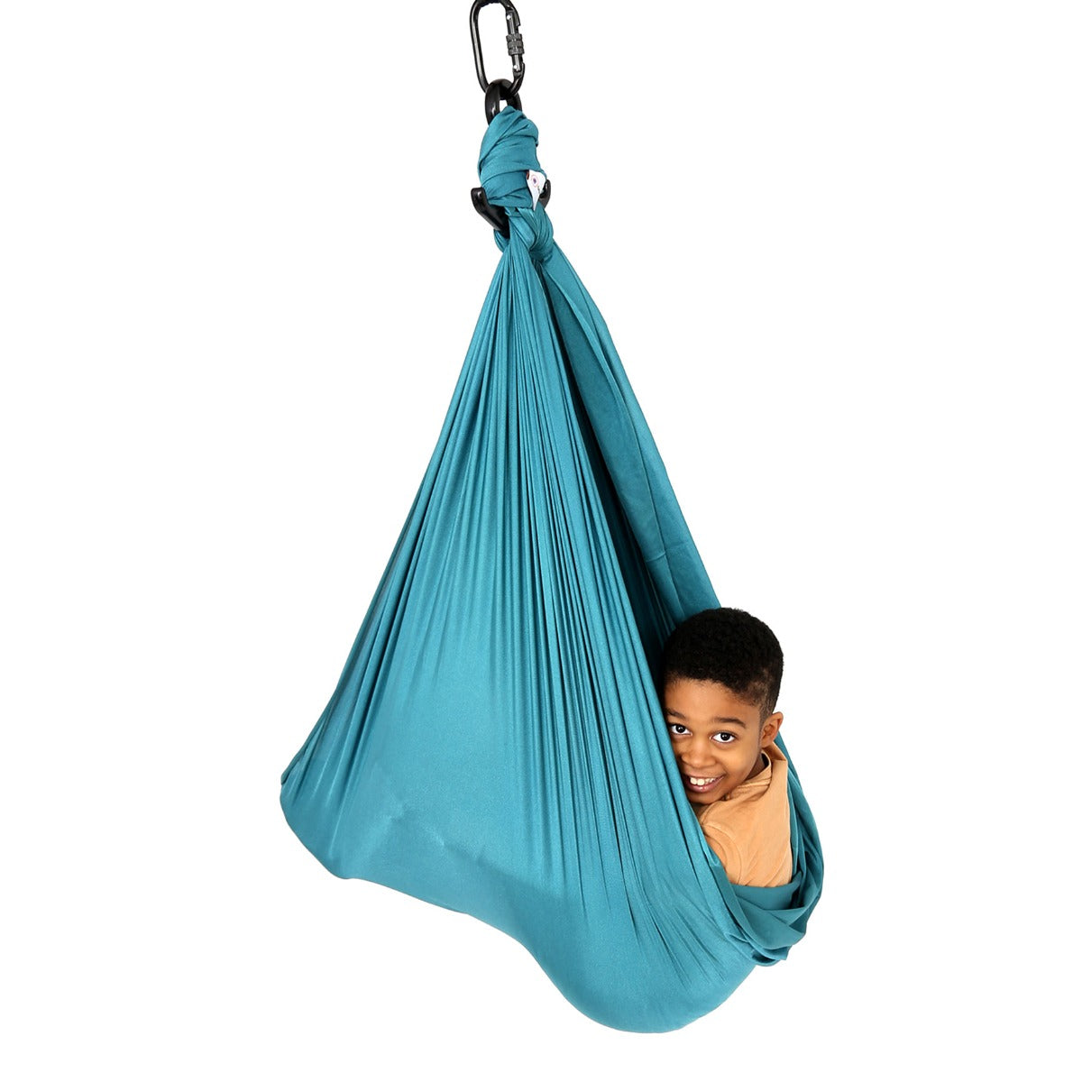 boy peeking out while laying inside the teal Cozy Compression Swing