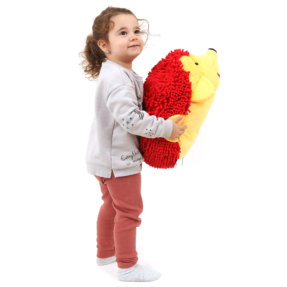 Girl smiling while holding Harry the Sensory Hedgehog