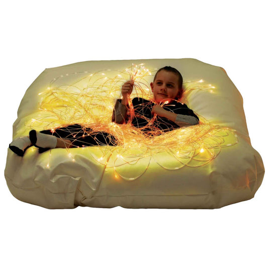 Woman using the SensaSoft™ Bean Bag Chair with Fiber Optic Strands