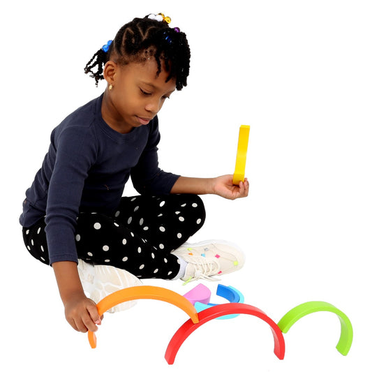 Girl playing with the Rainbow Stacker