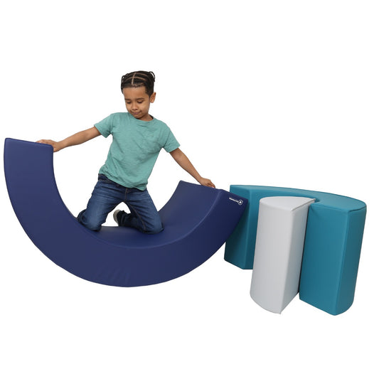 Boy smiling while playing with the SensaSoft Rainbow Playset