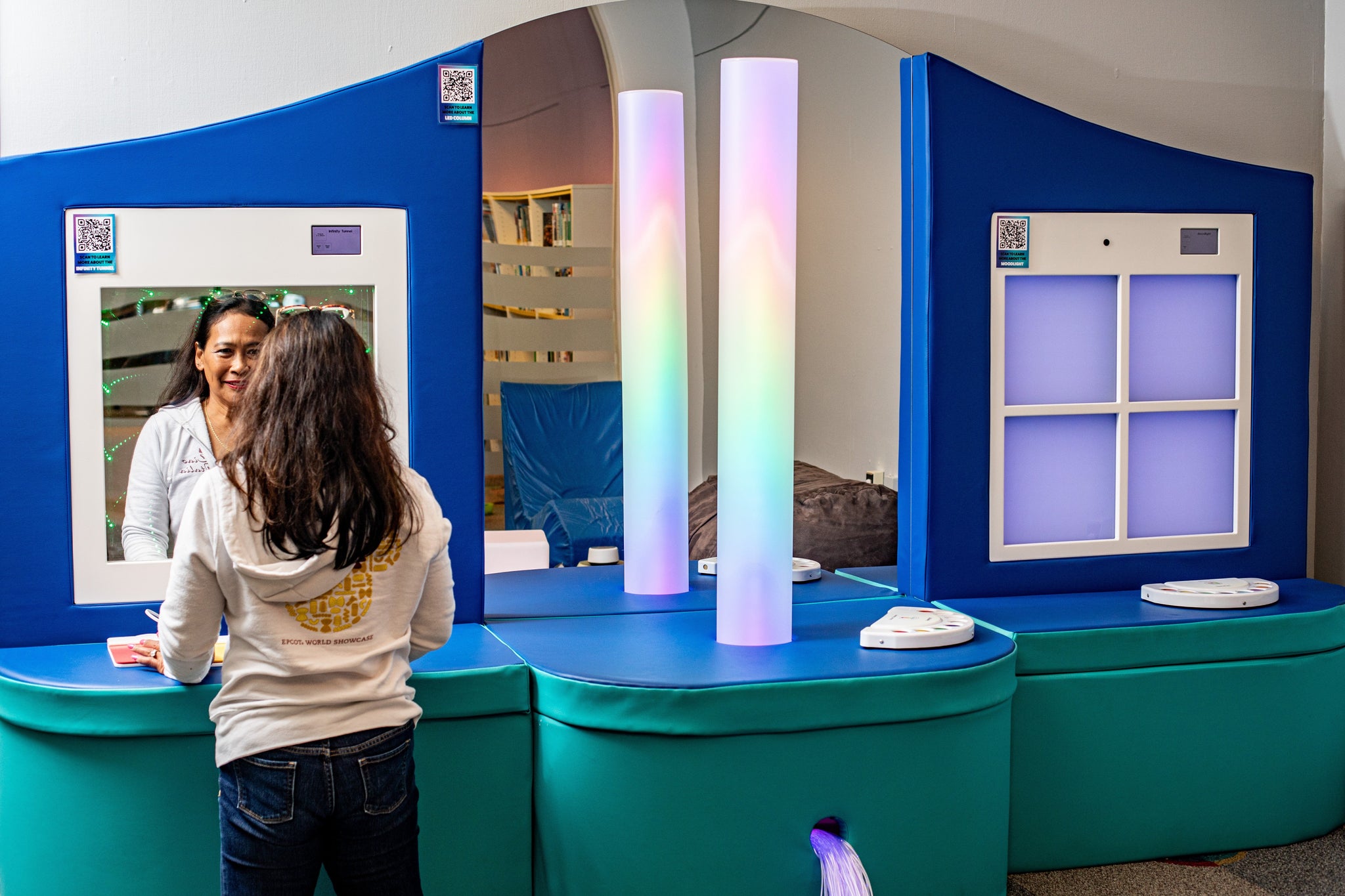 shows a person interacting with an Interactive Calming Station that includes a waterless color column