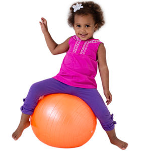 Girl sitting on the orange therapy ball