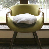 A chair with the Hand-Hugger Weighted Pillow on top
 