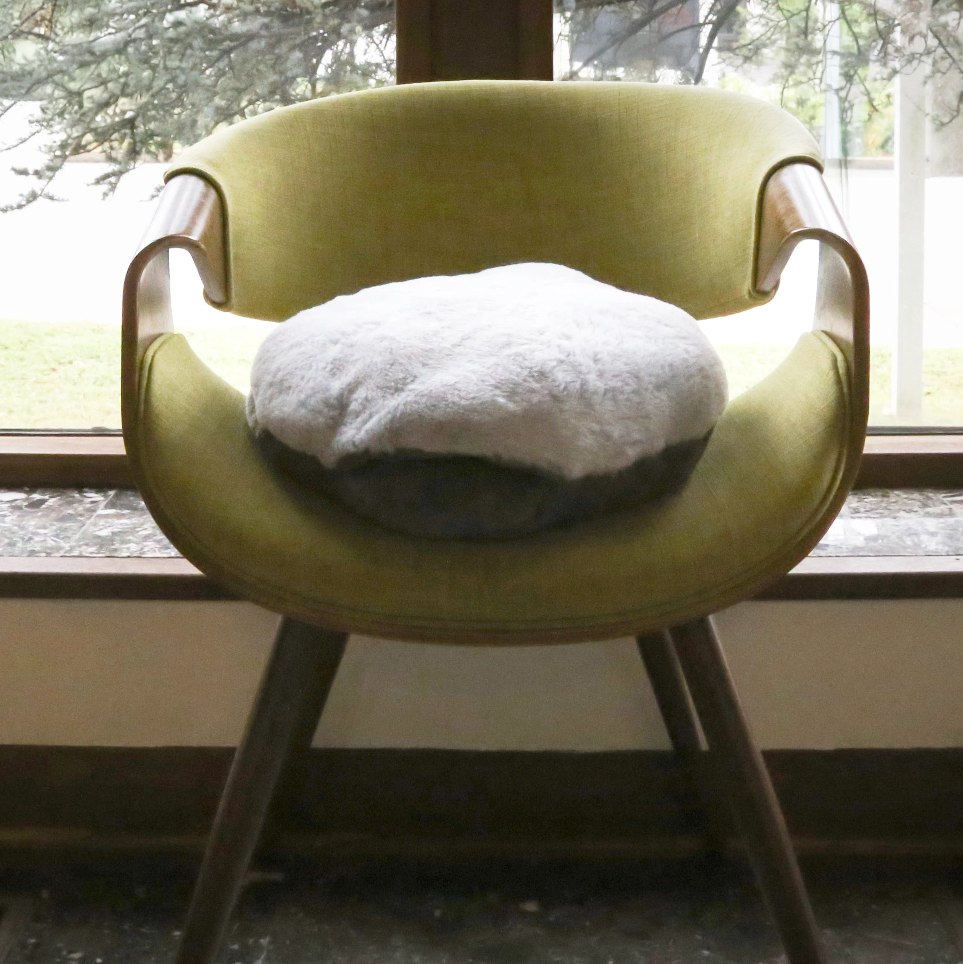 A chair with the Hand-Hugger Weighted Pillow on top
 