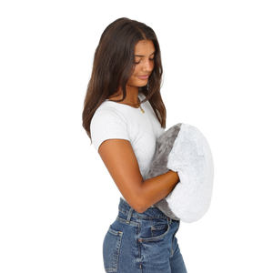 Girl holding the Hand-Hugger Weighted Pillow
 
