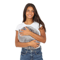 Girl smiling while holding the Hand-Hugger Weighted Pillow
 
