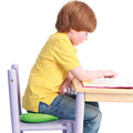 Boy at a desk sitting on the Neon green squishy