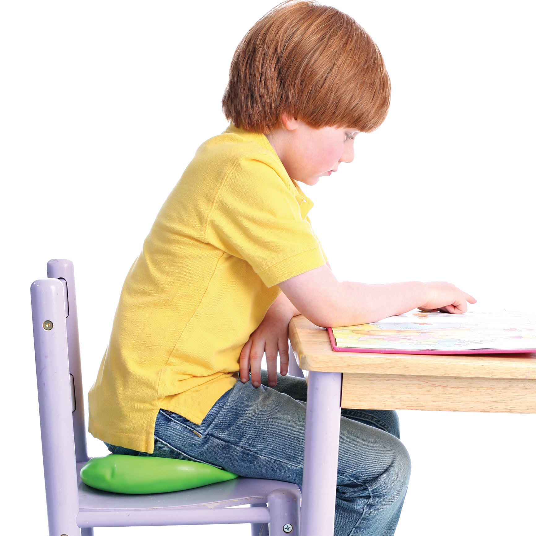 Boy at a desk sitting on the Neon green squishy