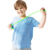 Boy smiling while using the green Chewy Fidget Coil