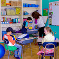 Boy using the green Boundary Chair in a classroom