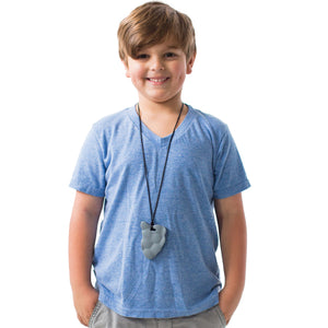 Boy smiling while wearing The Rock Chewy in the Color gray.  Black necklace and clasp