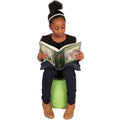 Girl using the Denim Weighted Lap Pad while reading