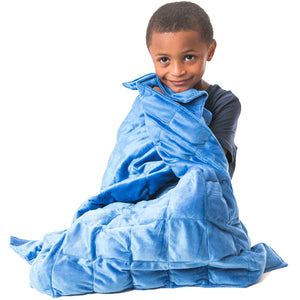 Boy smiling while using the blue Soft Plush Weighted Blanket