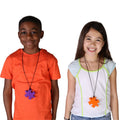 boy and girl smiling while wearing the Puzzle Piece Chewy necklaces