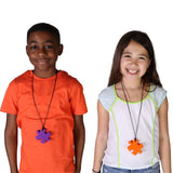 boy and girl smiling while wearing the Puzzle Piece Chewy necklaces