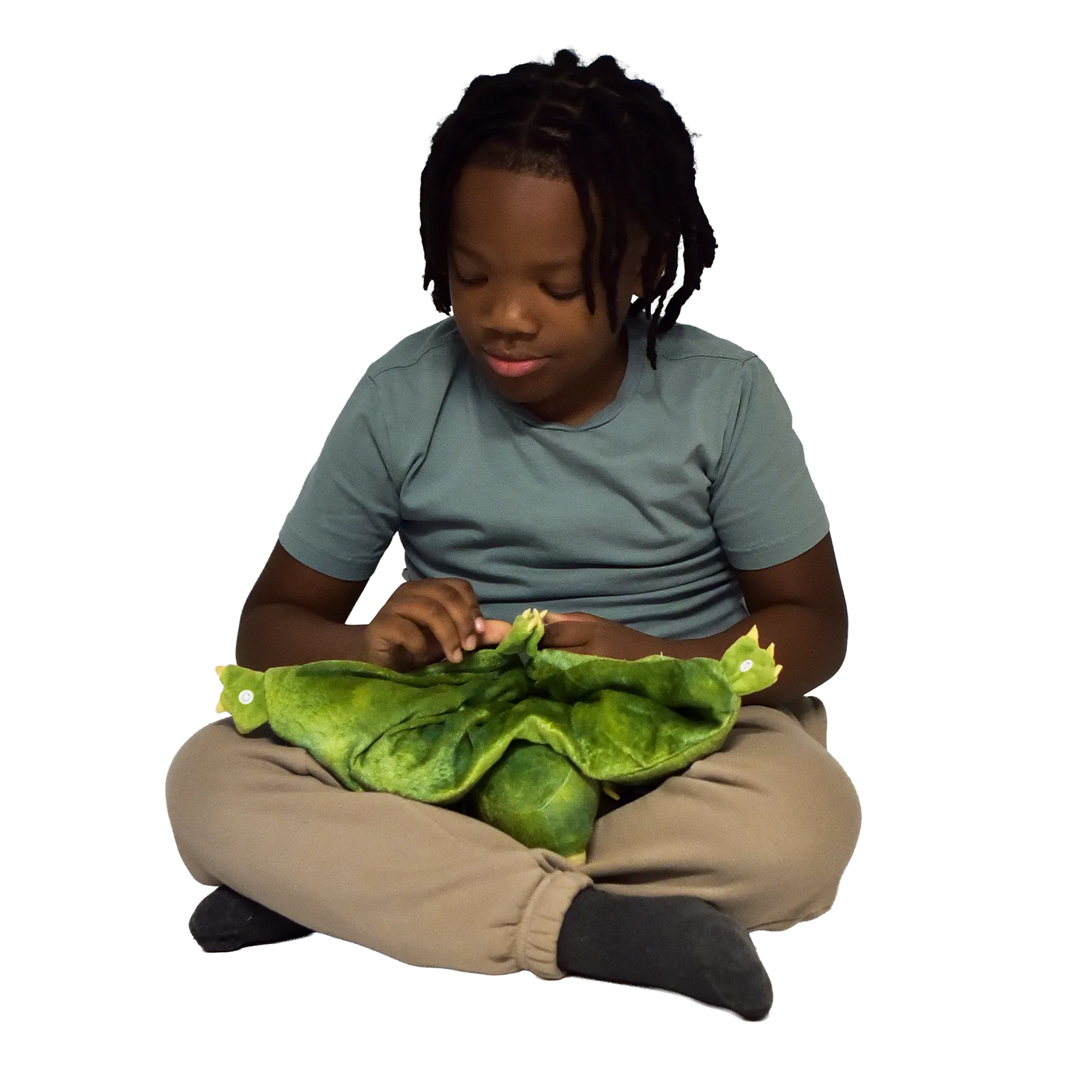 Boy sitting and holding the Weighted Animal Lap Pad
