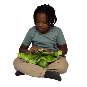 Boy sitting and holding the Weighted Animal Lap Pad