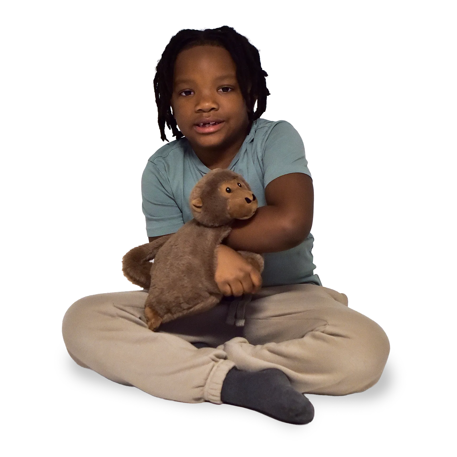 Boy sitting and holding the Weighted Animal Lap Pad