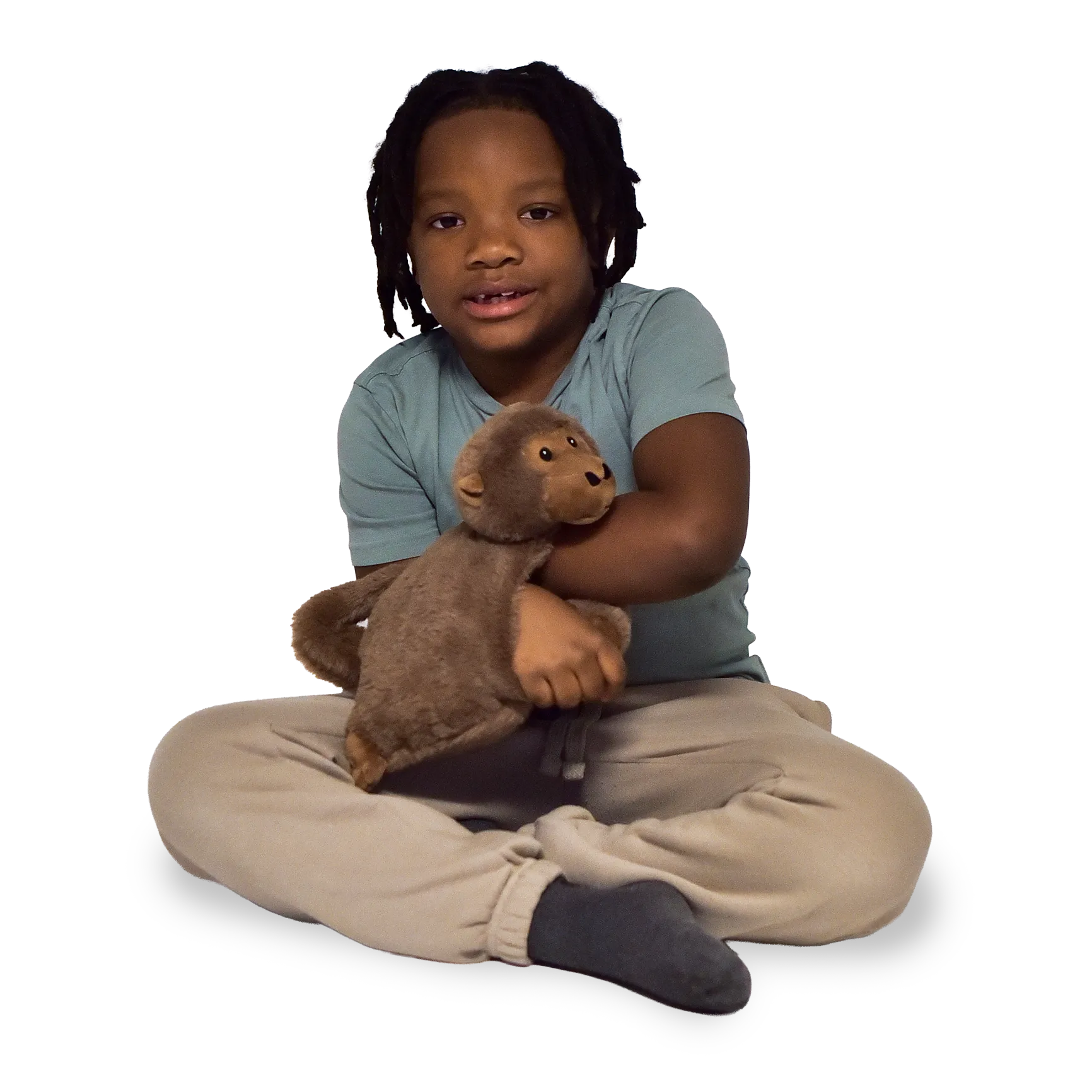 Boy sitting and holding the Weighted Animal Lap Pad