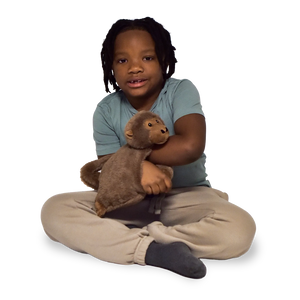 Boy sitting and holding the Weighted Animal Lap Pad