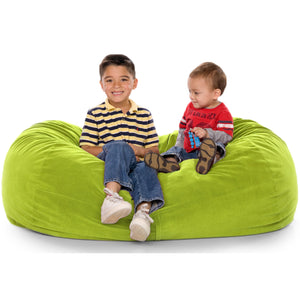 Young child and toddler sitting happily on a green  foam-filled Jaxx Lounger